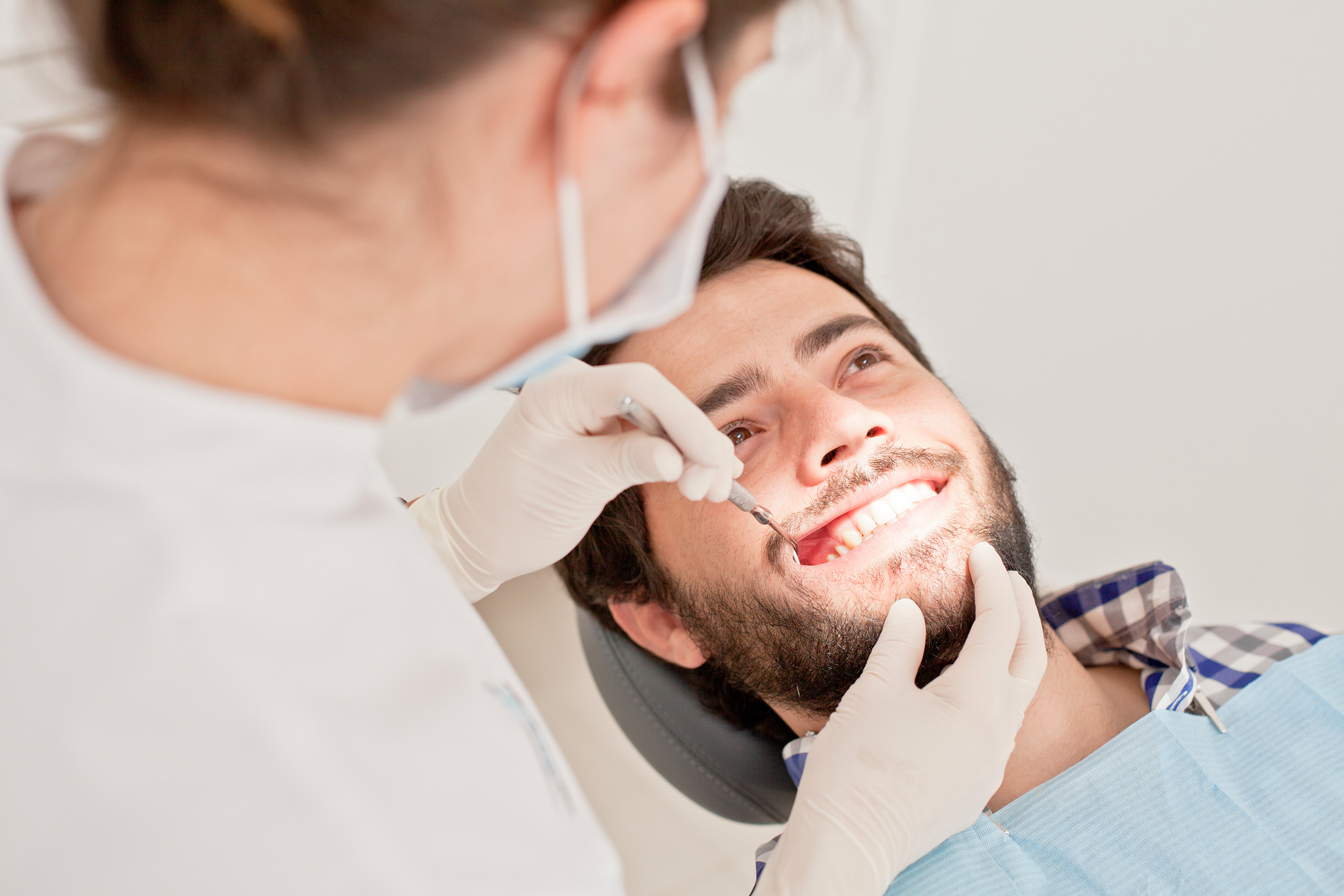 young happy man and woman in a dental examination at dentist