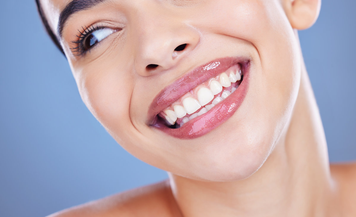 Dental, results and woman with mouth in studio for oral hygiene, healthcare and mouth wellness. Happy, client and closeup with smile for teeth whitening, cosmetics and treatment on blue background