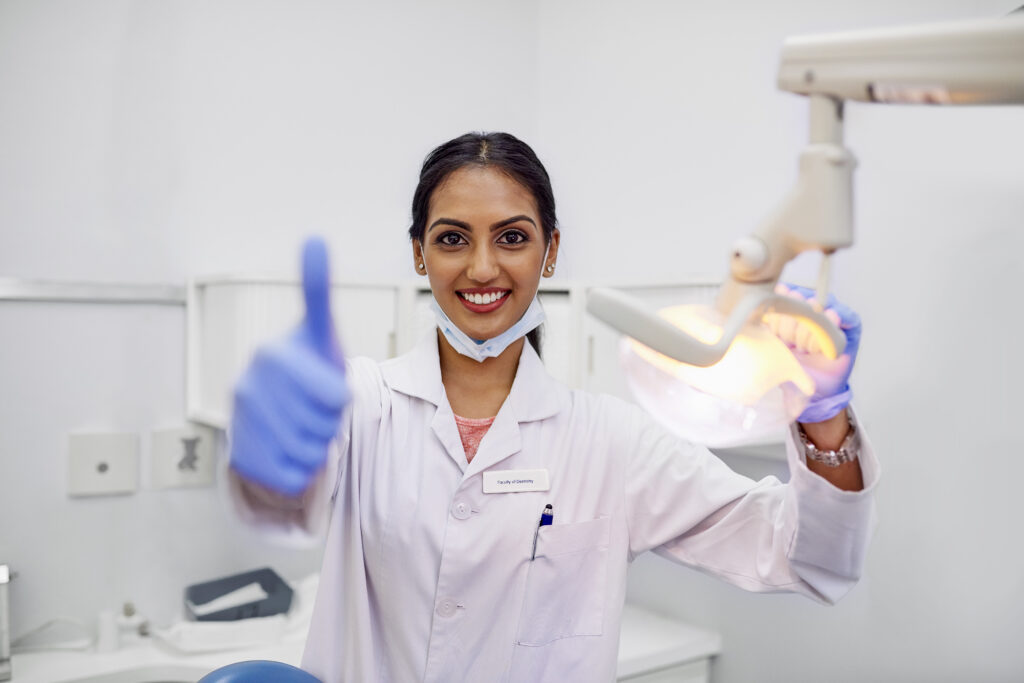 smiling dentist giving thumbs up in office 2026 03 25 03 55 15 utc