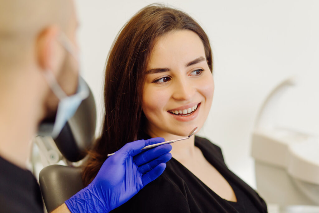 smiling woman during dental checkup at clinic 2026 03 09 23 51 37 utc