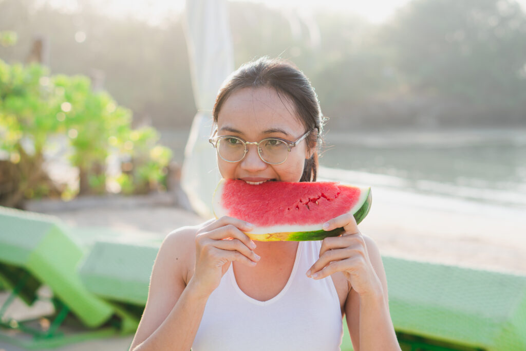 woman enjoying fresh watermelon on the beach 2026 03 13 01 31 50 utc
