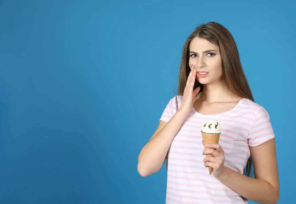 woman with toothache holding ice cream cone 2026 03 08 23 00 19 utc